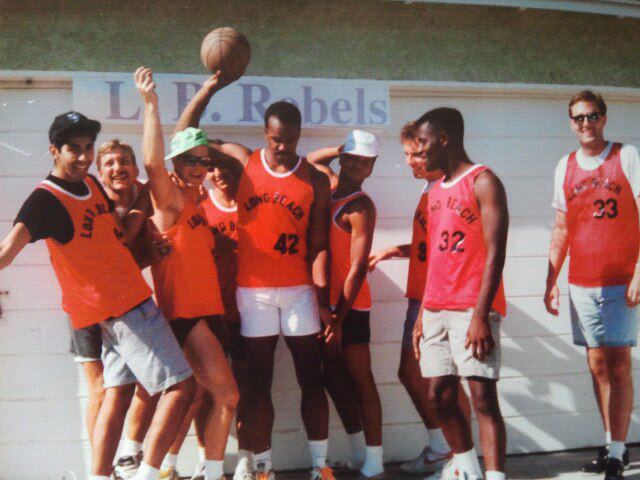 Group of men in a photo from 1991 after basketball practice. The men are wearing red practice uniforms.