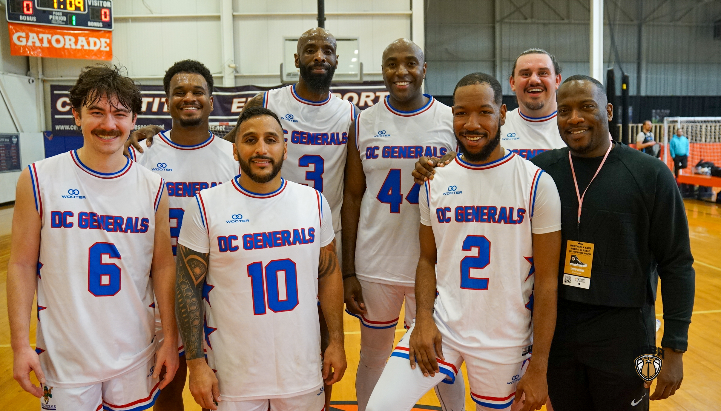 A basketball team poses for a group photo