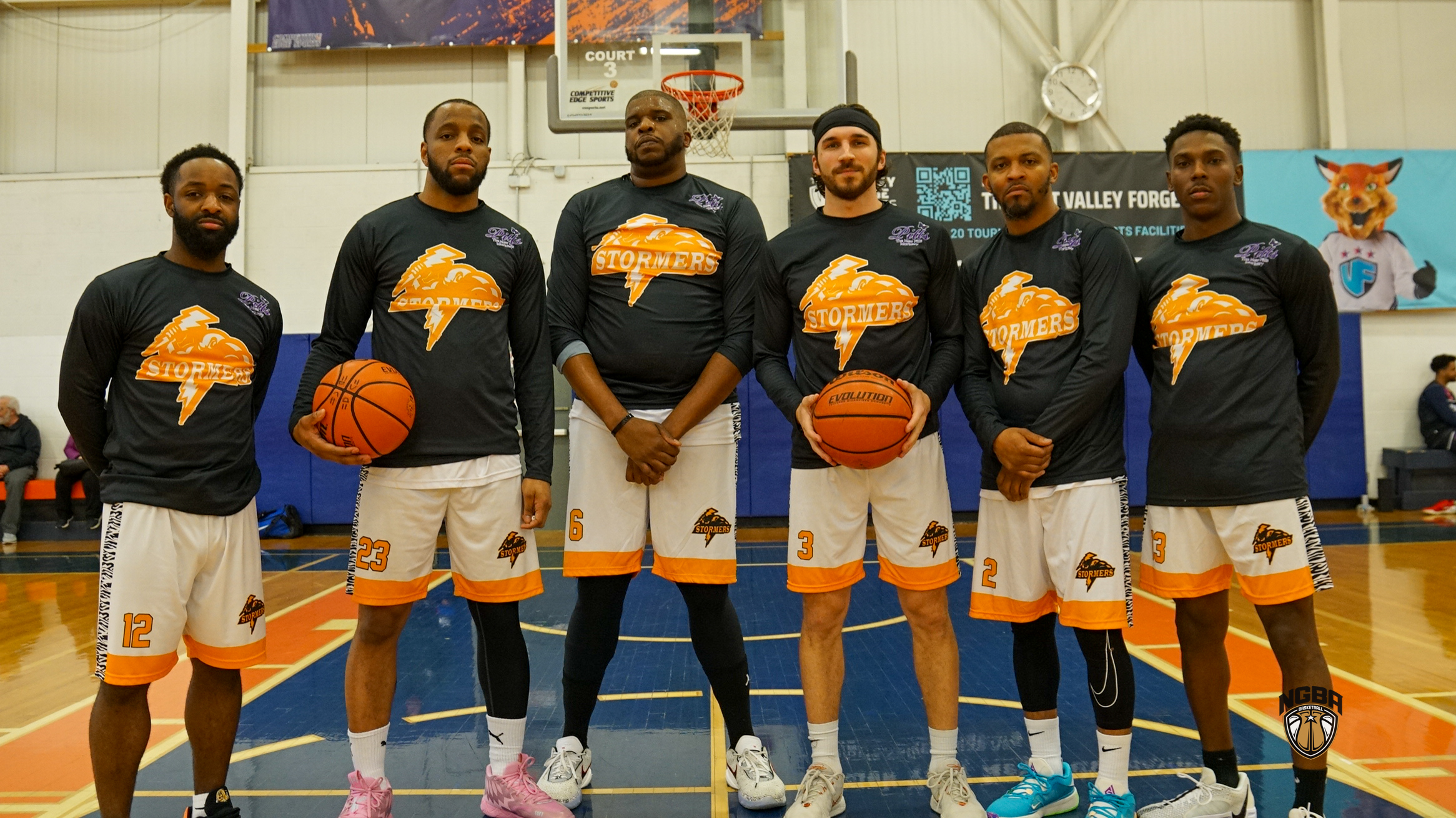 A basketball team poses for a group photo