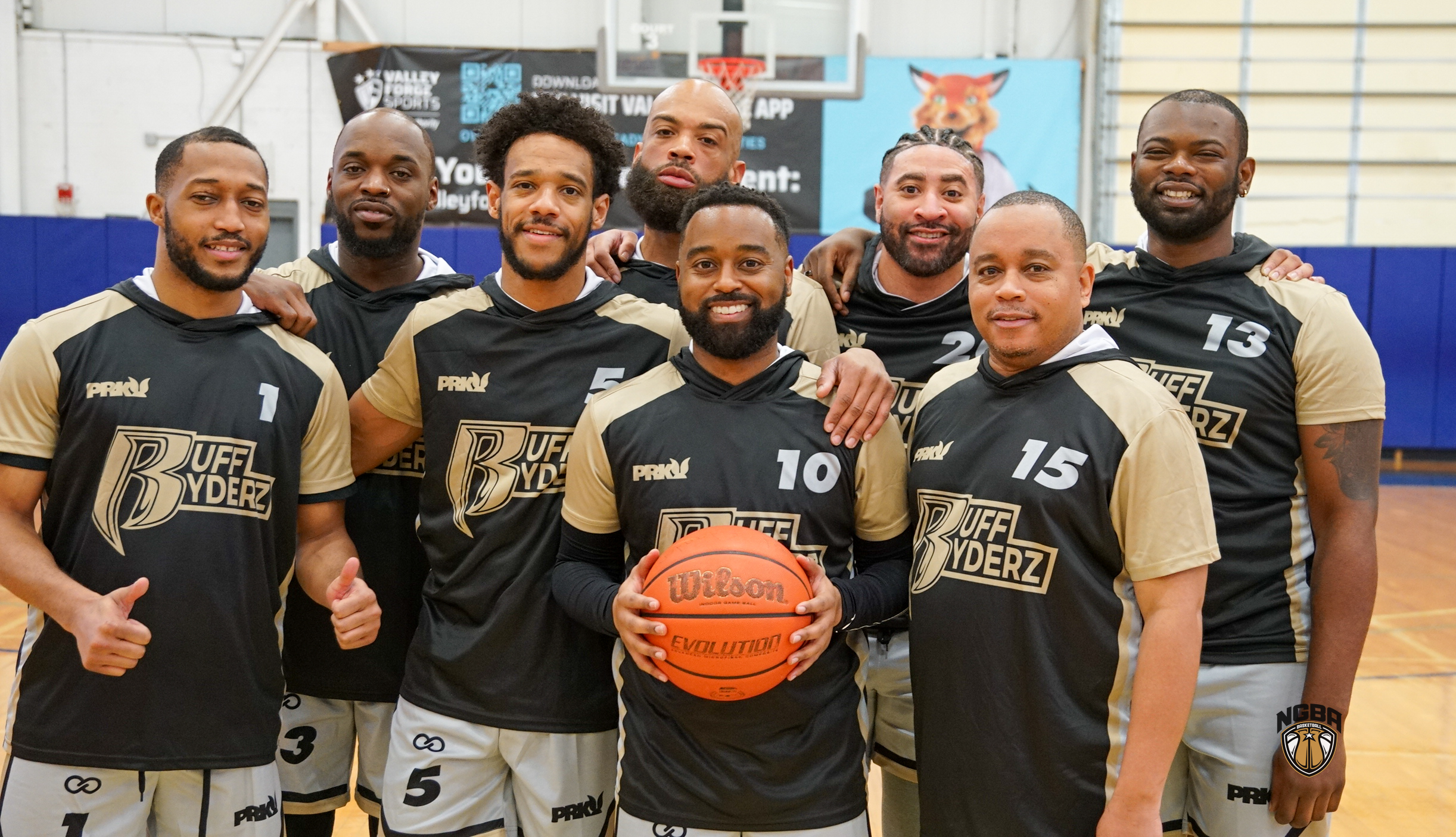 A basketball team poses for a group photo