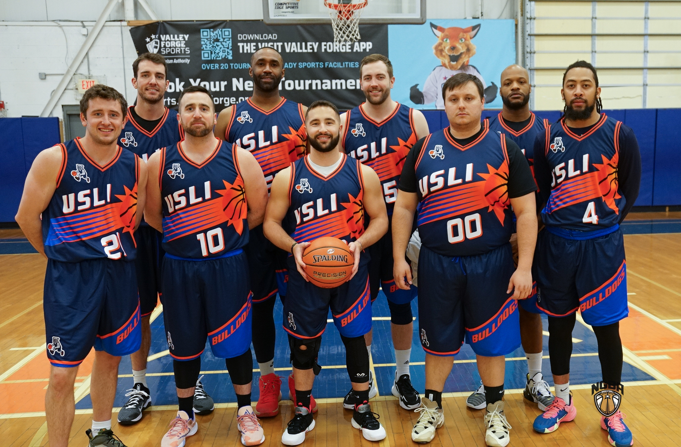 A basketball team poses for a group photo