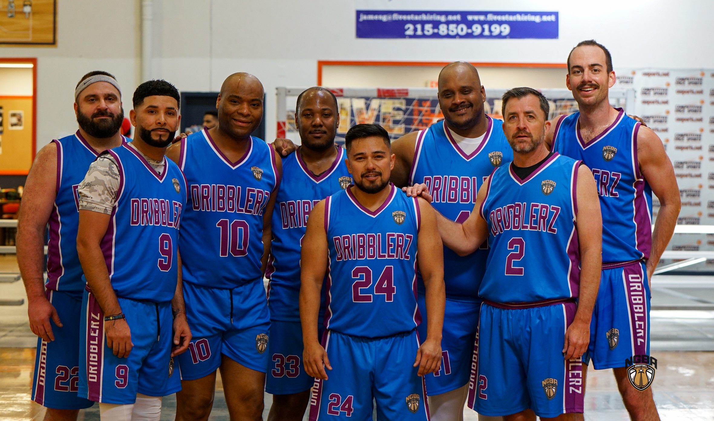 A basketball team poses for a group photo