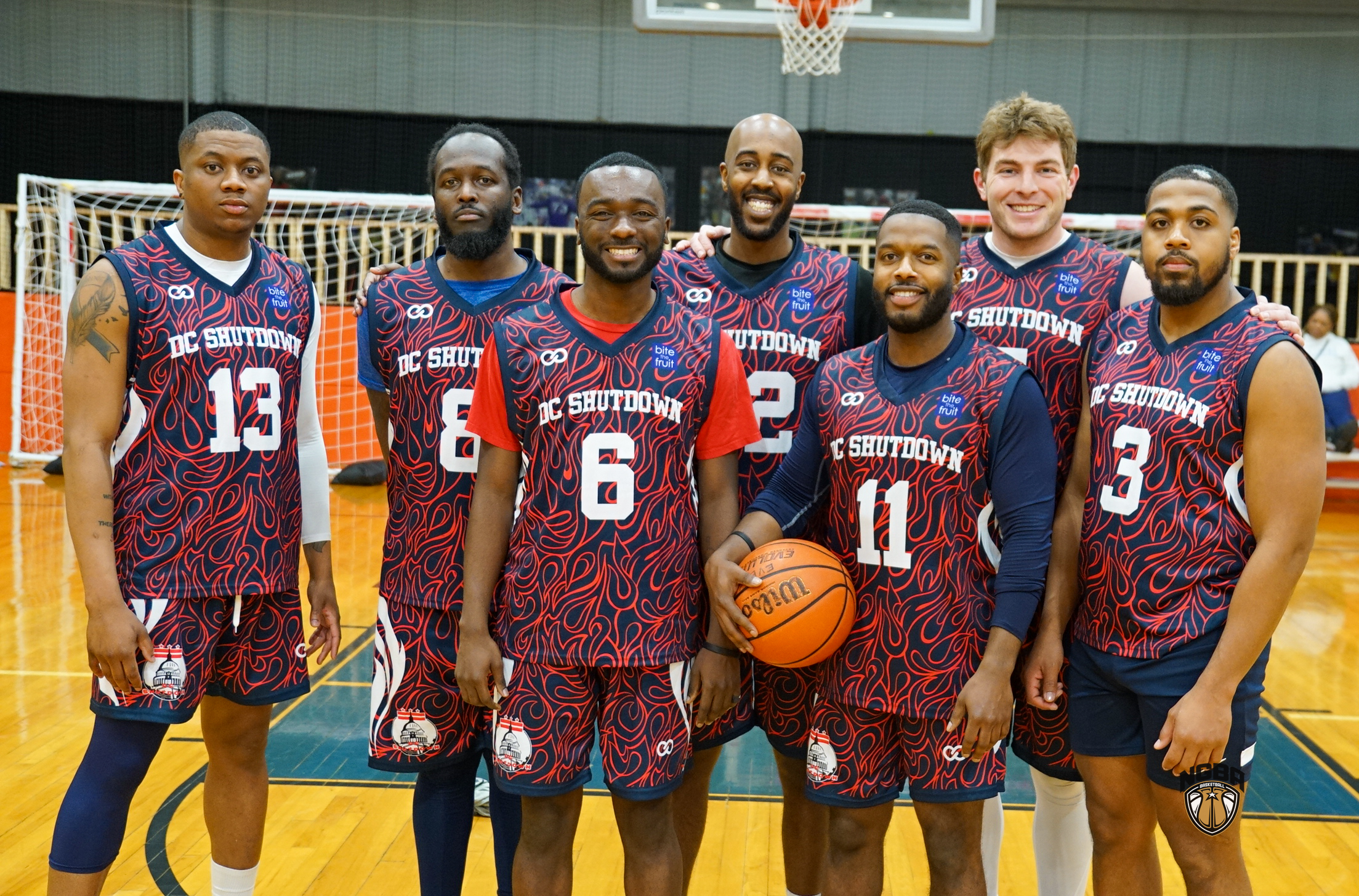 A basketball team poses for a group photo