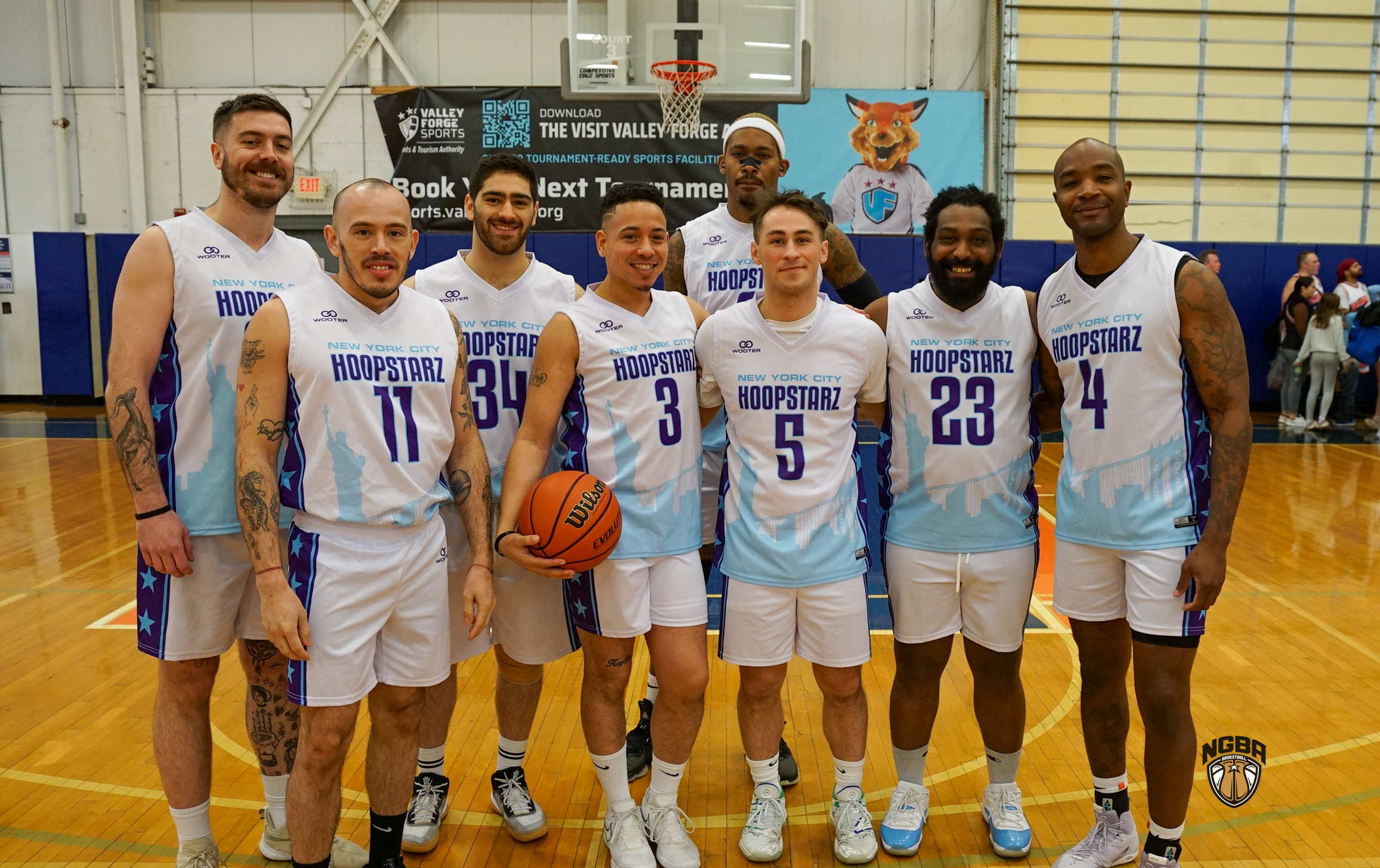 A basketball team poses for a group photo