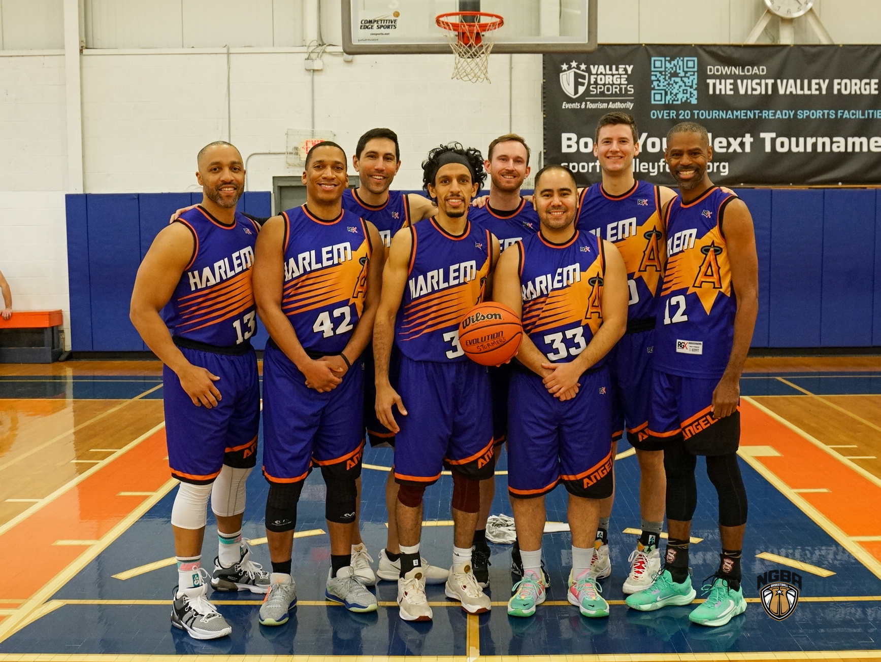 A basketball team poses for a group photo