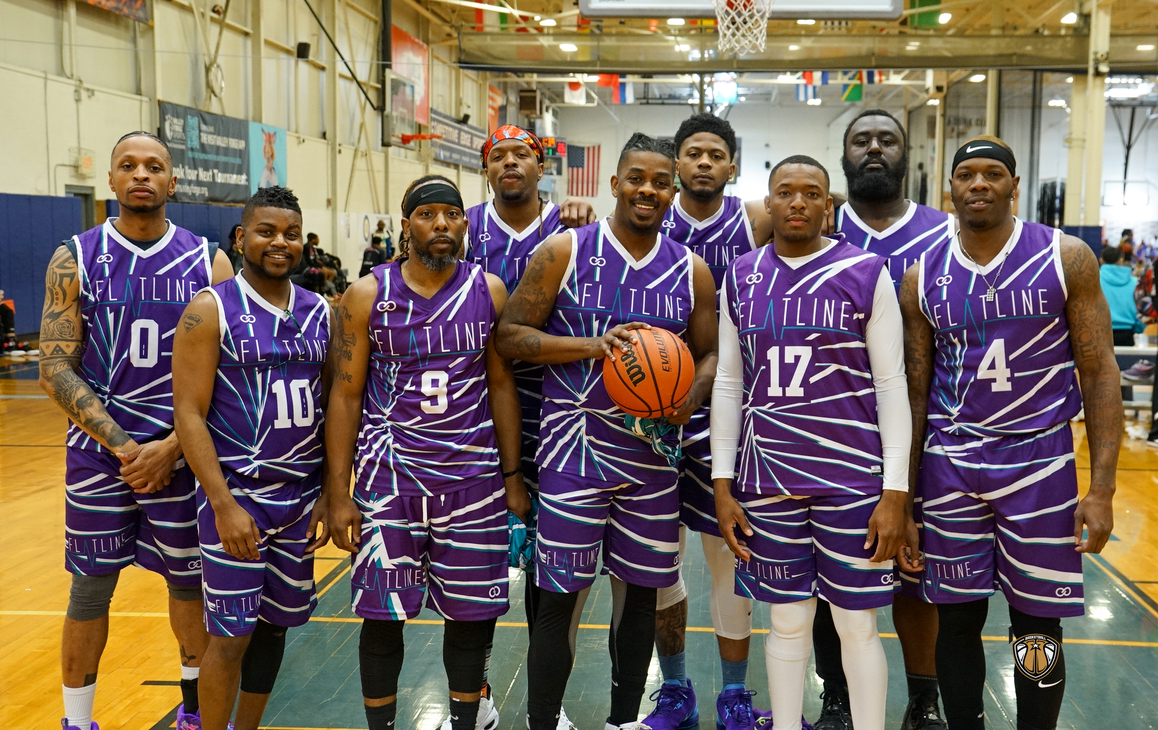 A basketball team poses for a group photo