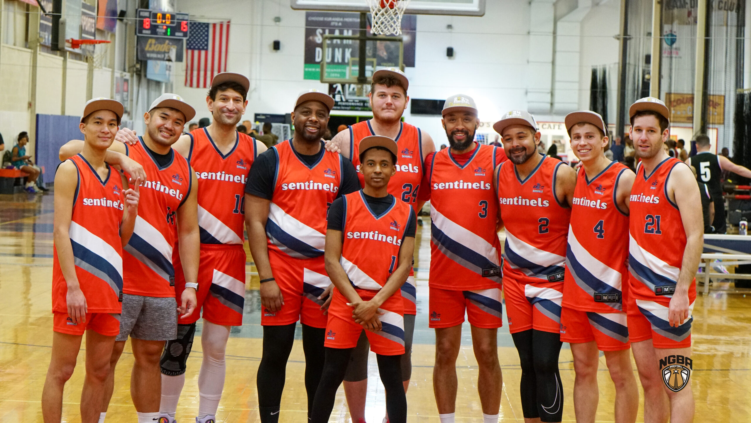 10 Men wearing basketball jerseys and championship hats pose for picture