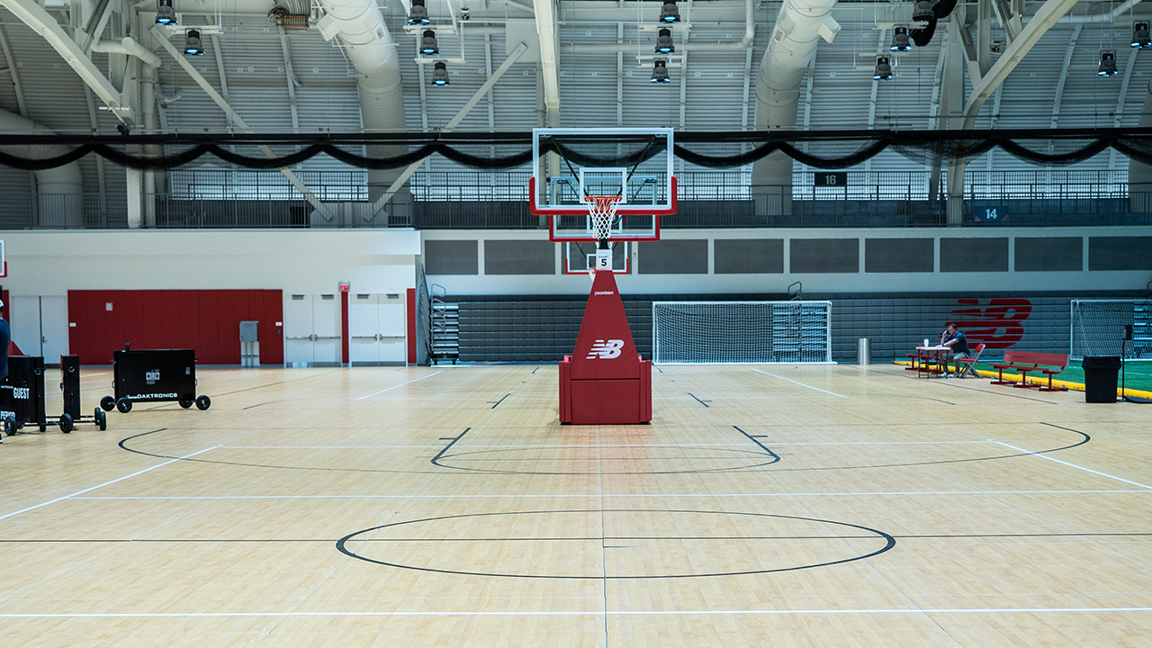 Empty Basketball court with a singular goal with red padding