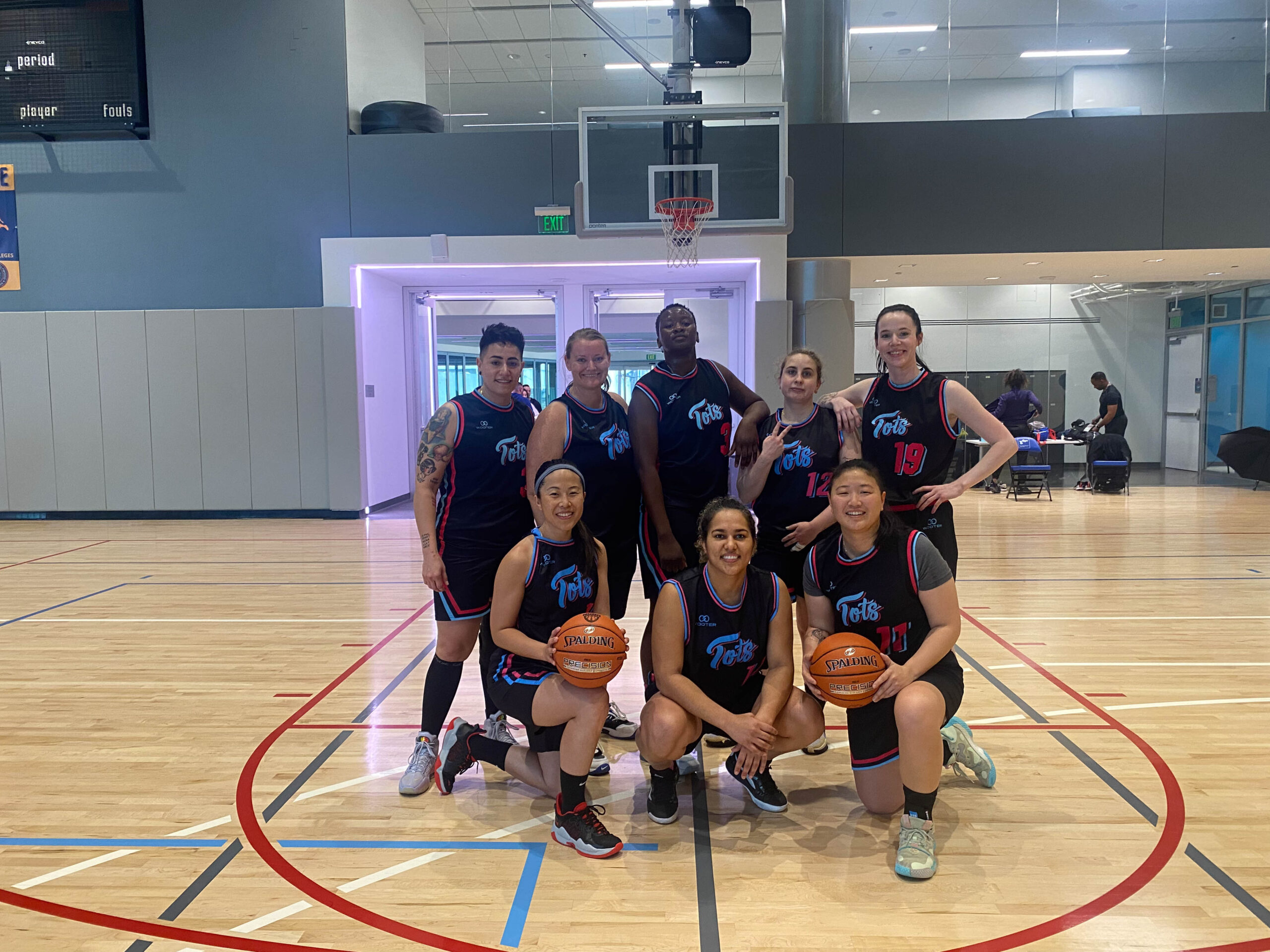 8 Women's+ players pose for a group photo