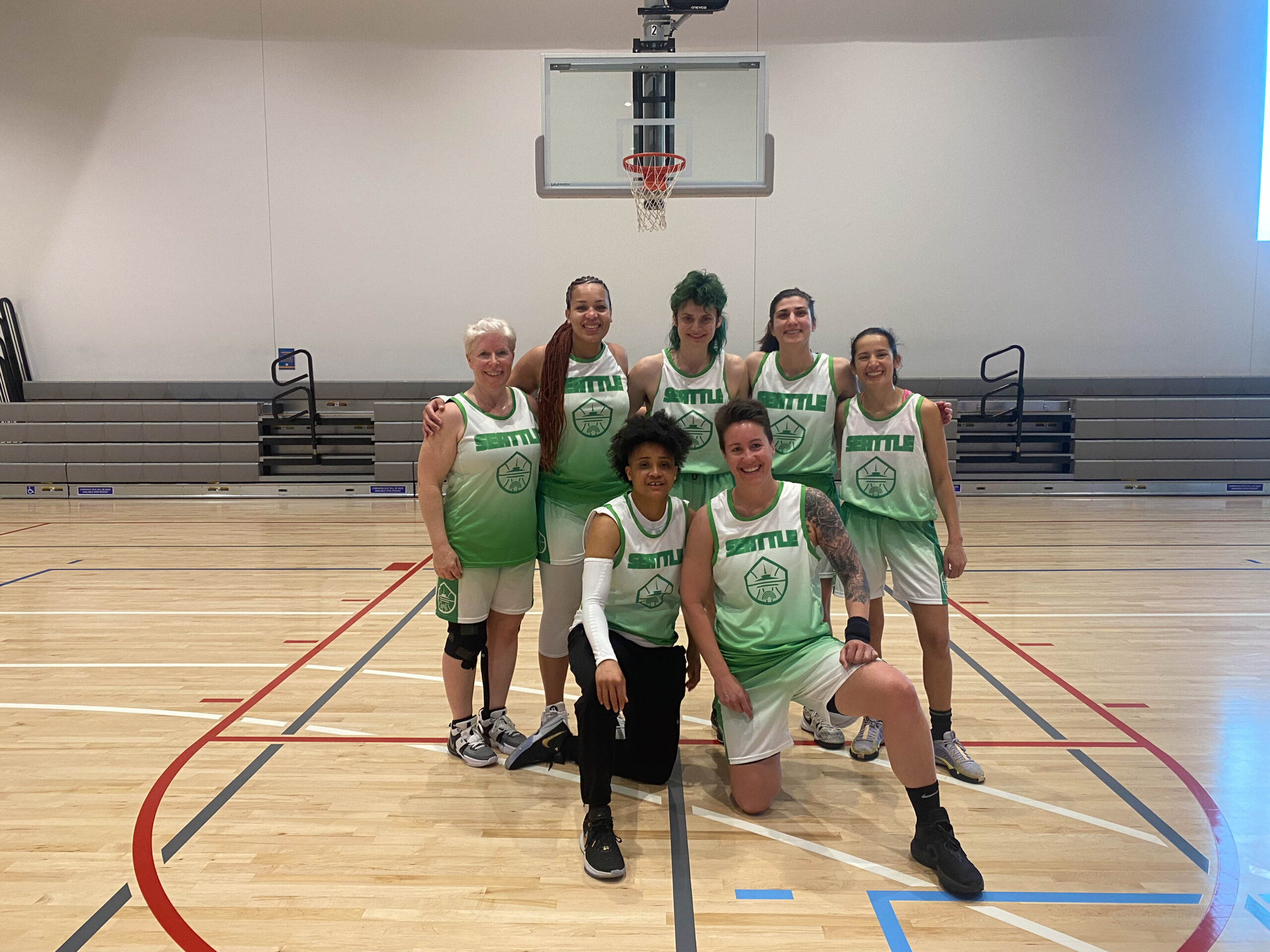 7 Women's+ players pose for a group photo