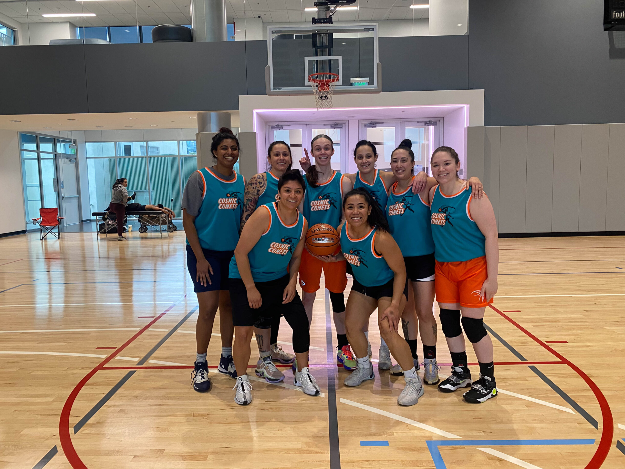 8 Women's+ players pose for a group photo