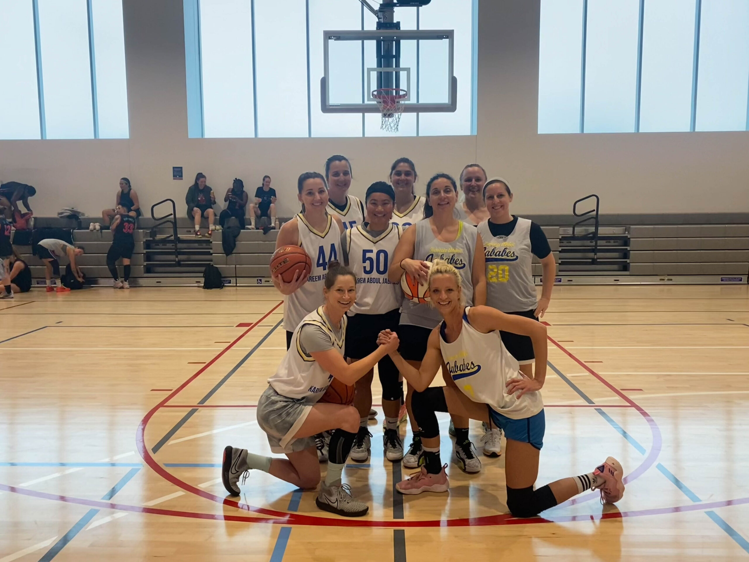 9 Women's+ players pose for a group photo