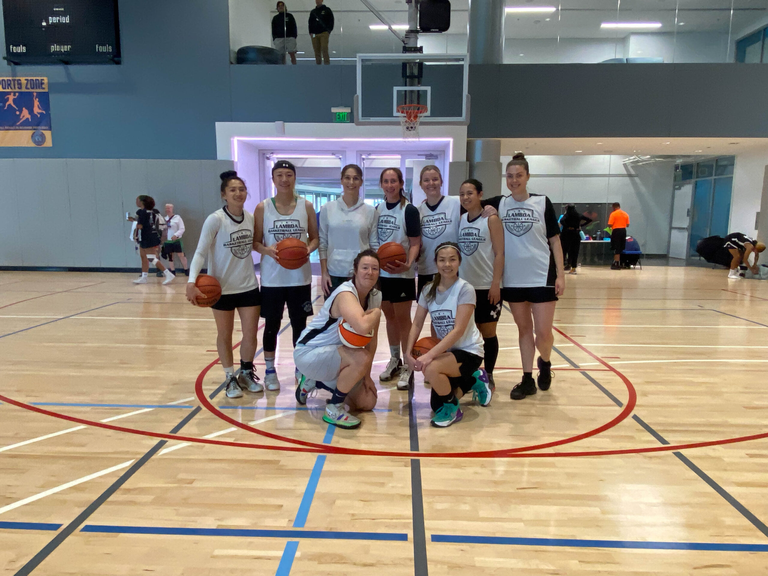 9 Women's+ players pose for a group photo