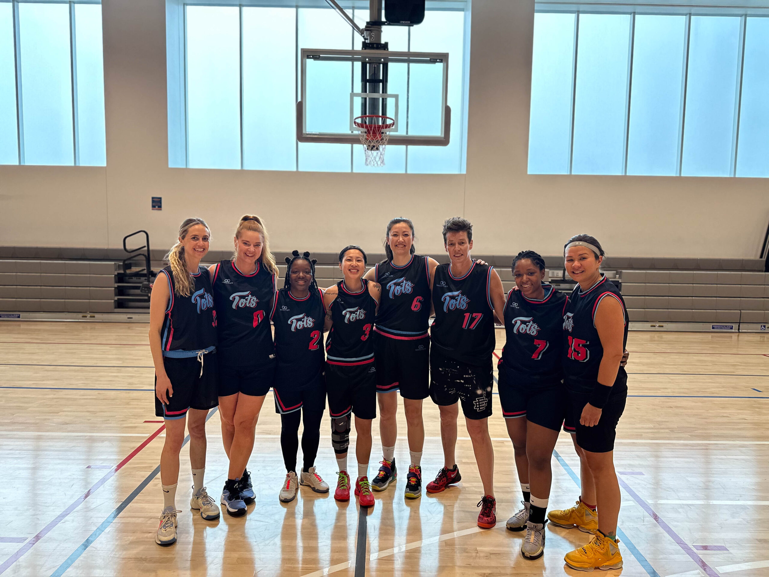 8 Women's+ players pose for a group photo