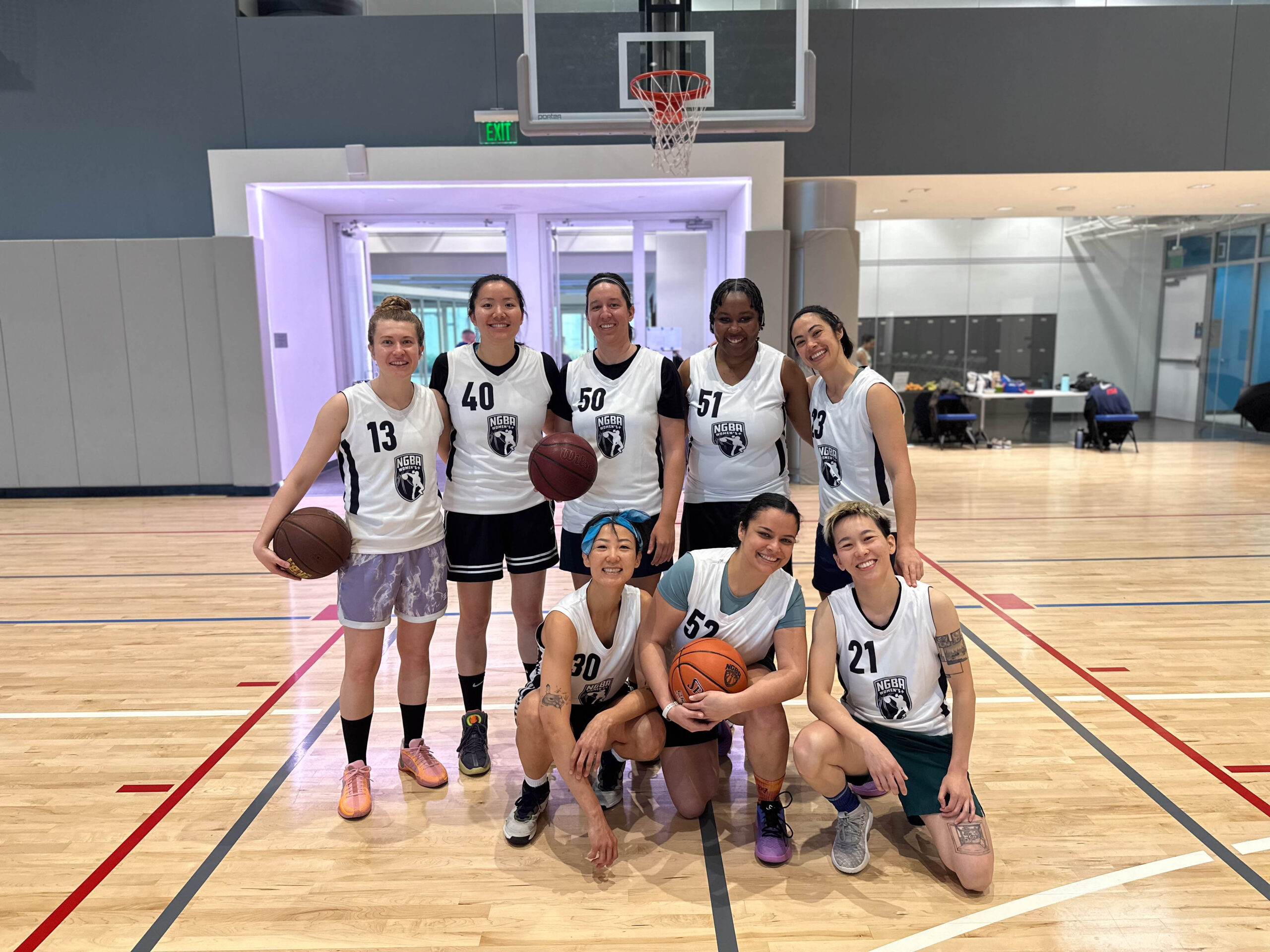 8 Women's+ players pose for a group photo