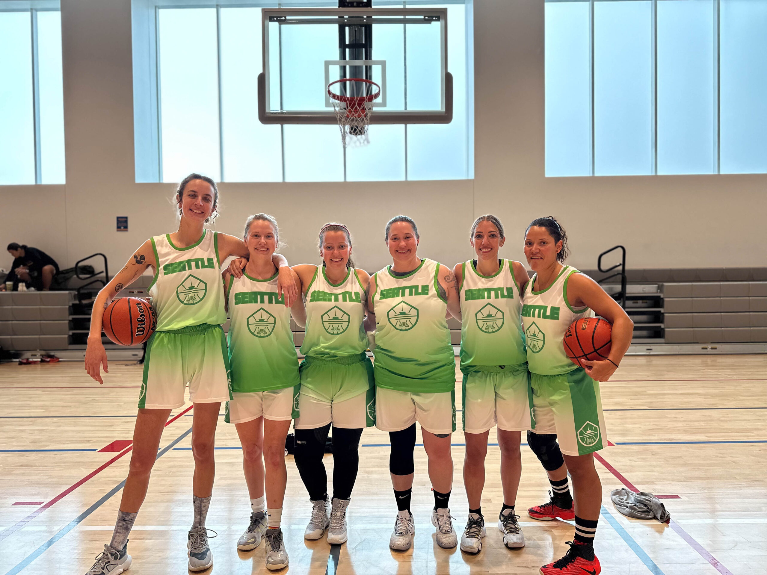 6 Women's+ players pose for a group photo