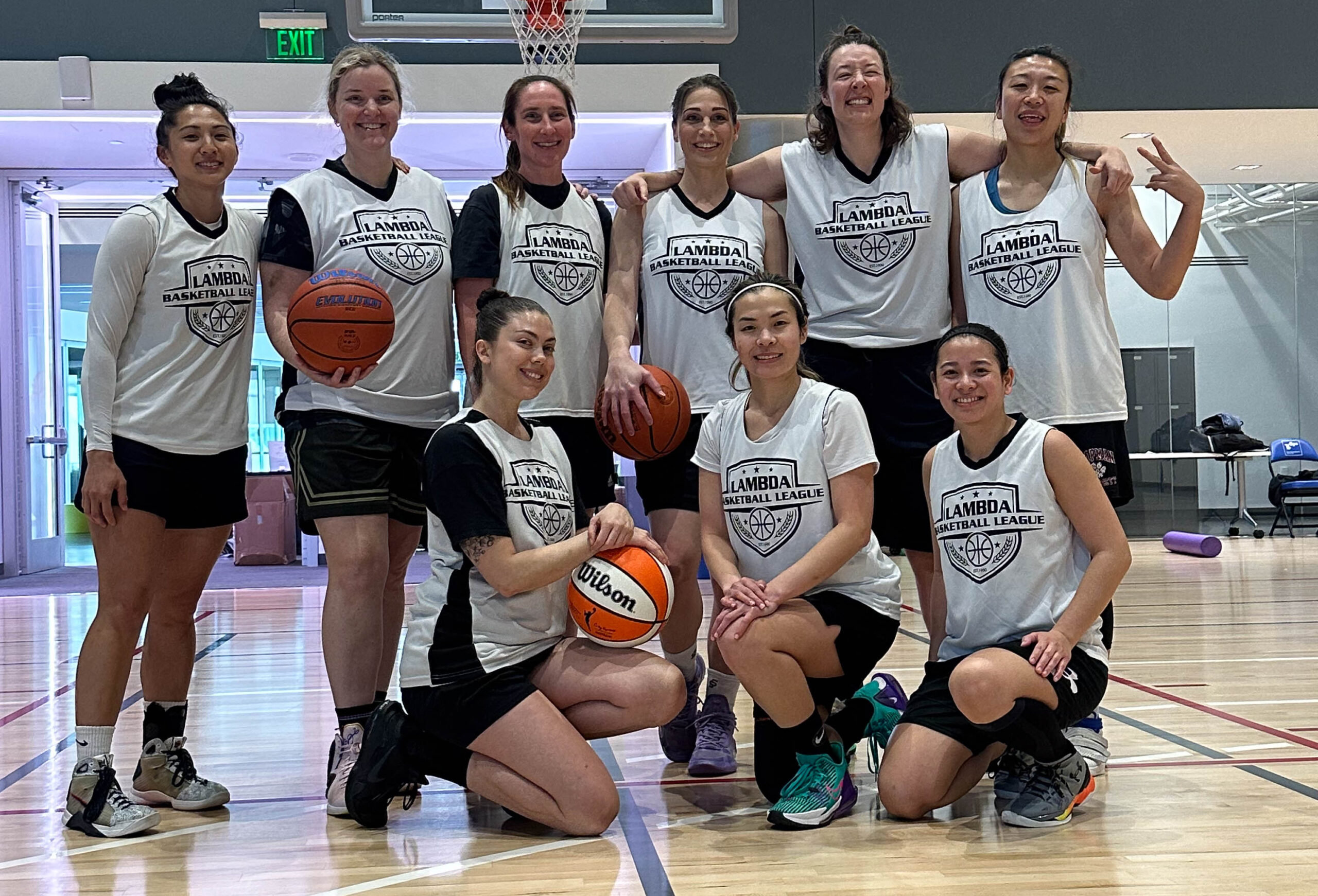 9 Women's+ players pose for a group photo