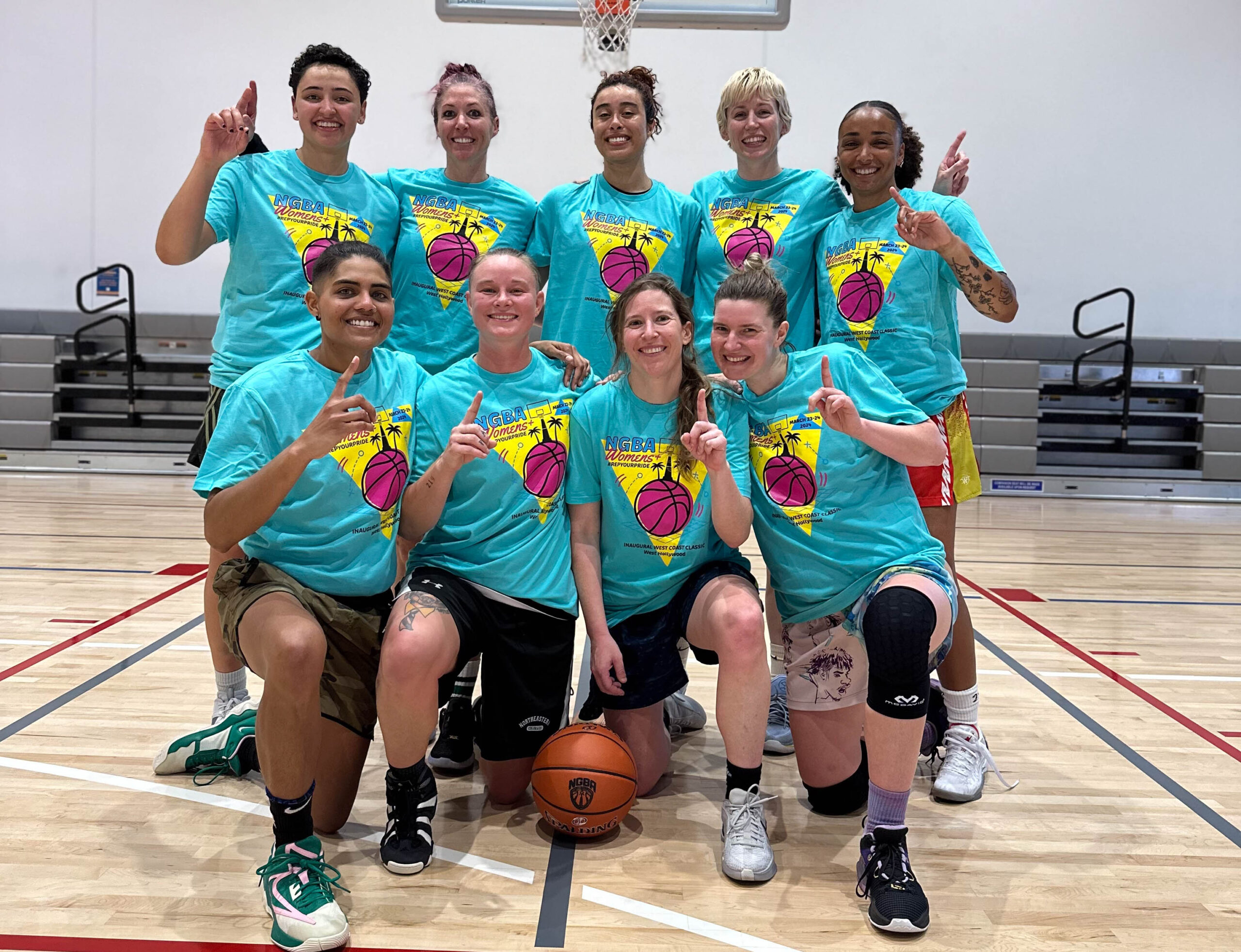 9 Women's+ players pose with championship shirts on