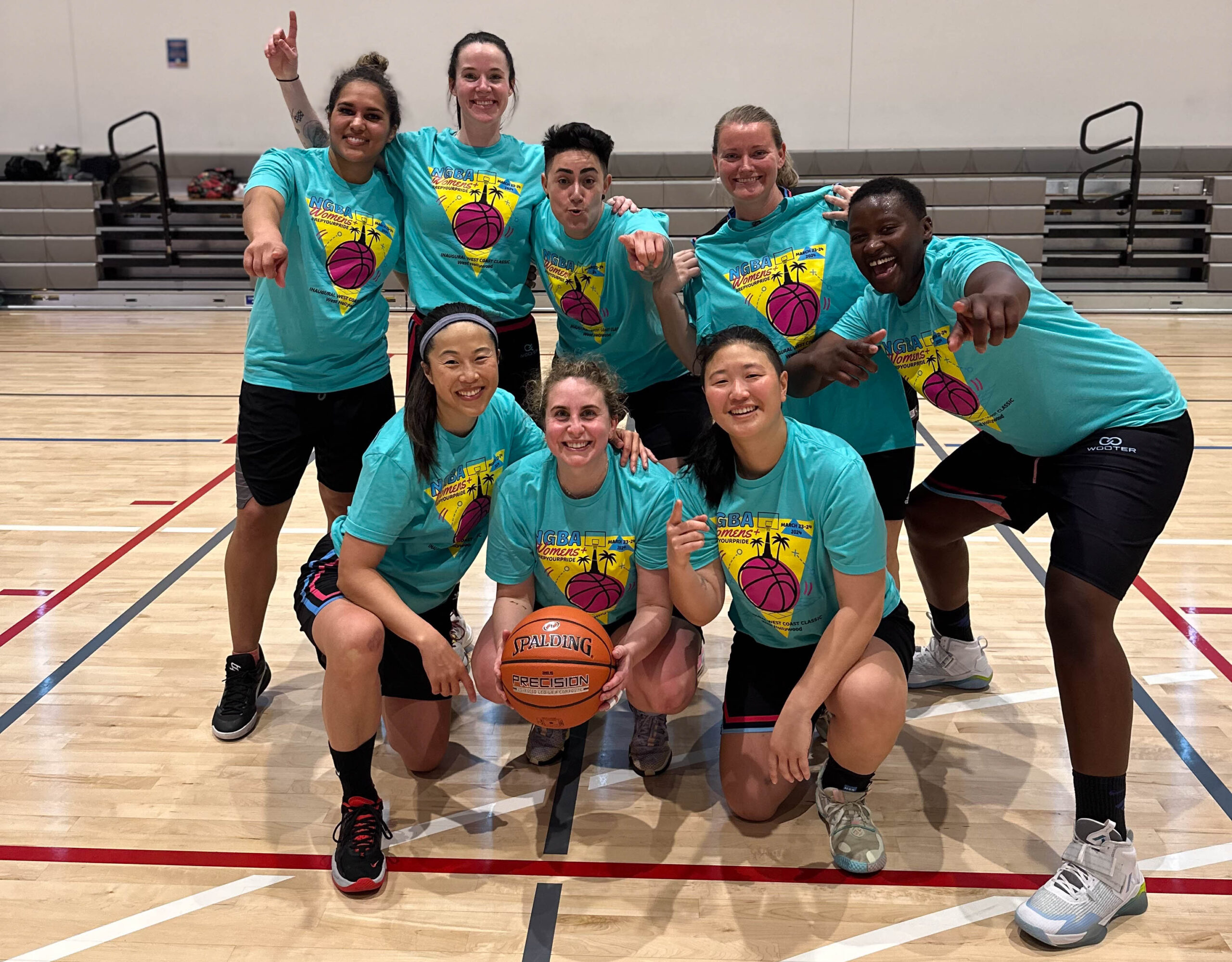 8 Women's+ players pose with championship shirts on